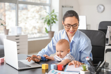 Working mother with her baby in office