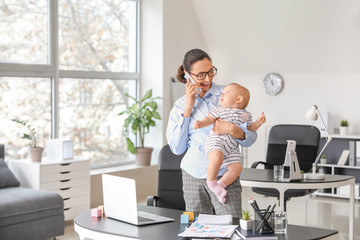 Working mother with her baby in office