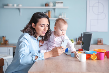 Working mother with her baby at home