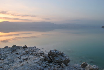 Fototapeta na wymiar Sunrise over the Dead Sea shore in Israel. The lowest place on Earth. Salt crystals at sunrise