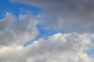 Bright white with grey clouds on blue sky. Beautiful background.