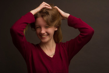 portrait of a girl in the Studio with painted blonde hair, in a red sweater