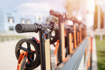 Electric scooters mobile on parking lot. City rental system bike, summer travel trip