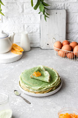 Green pancakes with matcha tea and mango jam