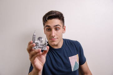 Young man holding a NEW YORK souvenir