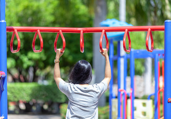 Fototapeta premium young athletic fitness woman working out at outdoor gym.