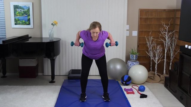 Sandra works the arms and deltoids with a row exercise
