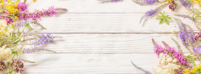 wildflowers on white wooden background