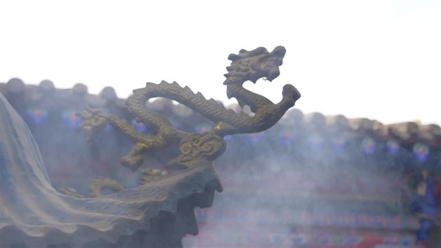 Foggy incense smoke in the air and dragon sculpture in Temple of NanShan Mountain, Xining Qinghai China.