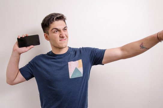 Angry Young Man Throwing A Phone