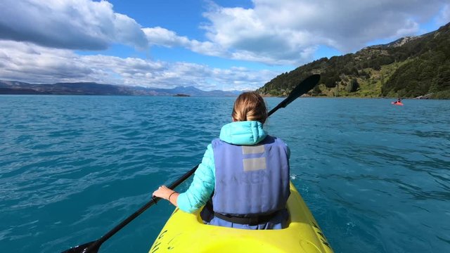 Woman explores limestone rock formation and swims inside the cave (Marble Caves) on the lake General Carrera in Chilean Patagonia, Aysen region, Chile