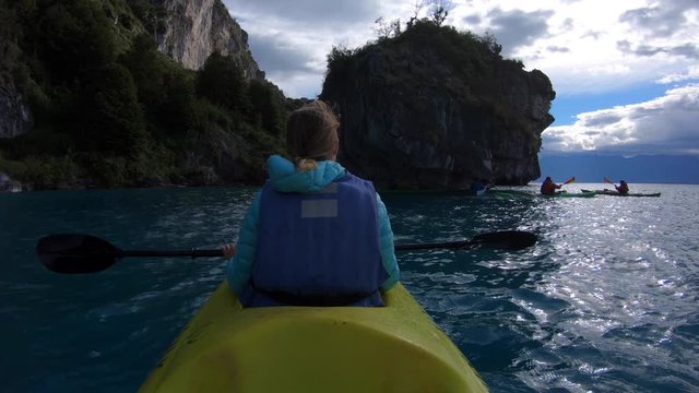 Woman explores limestone rock formation and swims inside the cave (Marble Caves) on the lake General Carrera in Chilean Patagonia, Aysen region, Chile