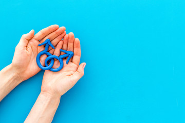 LGBT concept. Male Mars symbol in hands on blue background top-down copy space