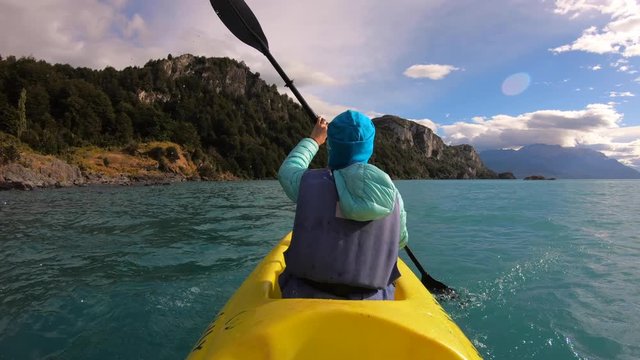 Woman explores limestone rock formation and swims inside the cave (Marble Caves) on the lake General Carrera in Chilean Patagonia, Aysen region, Chile
