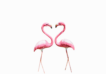 Two pink flamingos statues on isolated white backgrounds