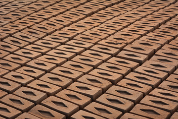 Raw brick laid out in stacks for drying. Bricks in a brick factory. Traditional production of clay bricks in India.