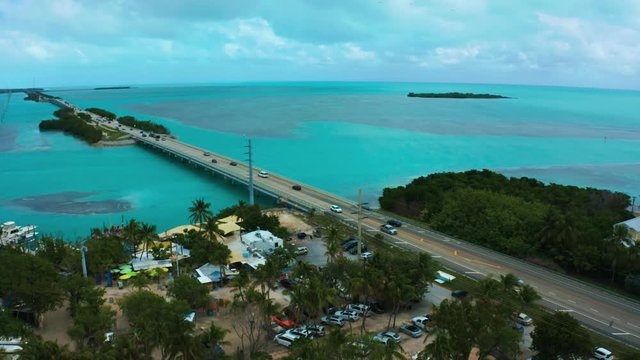 Aerial 4K UHD drone footage of the famous Highway One leading from Miami Beach all the way down to Key West in Florida. The turquoise Atlantic Ocean is  surrounding the hundreds of coral reef islands.