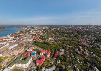 Aerial view of Tomsk city with a lot of trees and Tom river. Summer, sunny day.