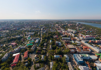 Aerial view of Tomsk city with a lot of trees and Tom river. Summer, sunny day.