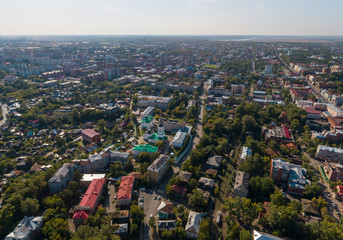 Aerial view of monastery in Tomsk city with a lot of trees. Summer, sunny day.