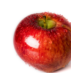 Red apple with drops of water on a white background. Close-up.