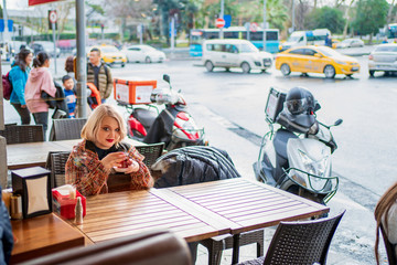 Blonde in a cafe drinking hot tea