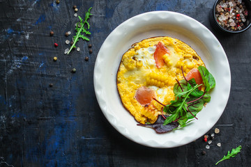 omelette scrambled vegetables and salad, healthy snack (corn, tomato, onion and other ingredients) menu concept background. top view. copy space