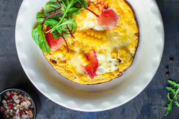 omelette scrambled vegetables and salad, healthy snack (corn, tomato, onion and other ingredients) menu concept background. top view. copy space