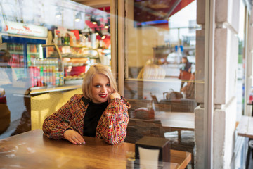 Blonde in a cafe drinking hot tea