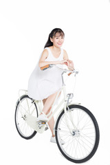 beautiful woman riding a bicycle against white background.