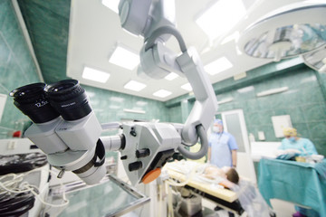 surgical microscope on the background of modern neurosurgical operating room and doctors