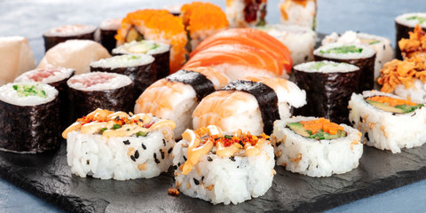 Large sushi set panoramic close-up. An assortment of various maki, nigiri and rolls