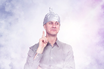 Funny man in an aluminum hat in the smoke. Concept art phobias