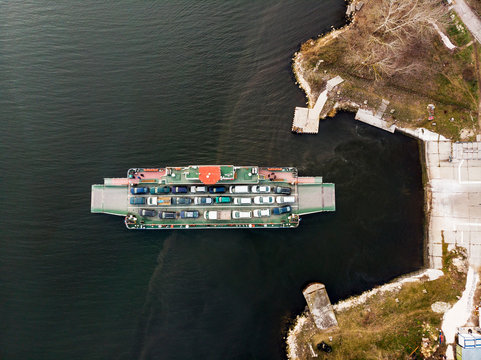 Ferry boat transport cars in Beloslav canal. Aerial drone top view. Bulgaria. 