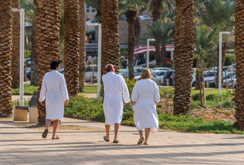 Fototapeta na wymiar Holiday makers at the Dead sea resort, Israel