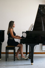Woman plays a piano