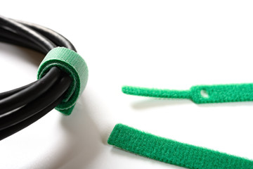green velcro cable tie and cable on white