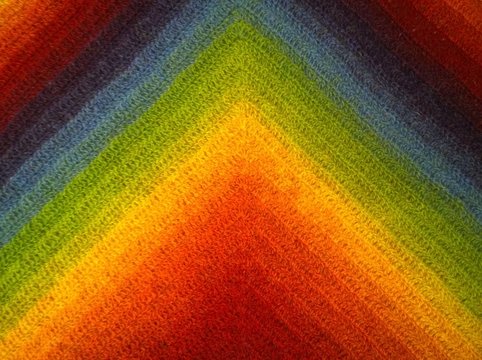 Background from a gradient of colors of the rainbow: burgundy, red, orange, yellow, green, classic blue, violet, blueberry. Beauty of geometry. Triangles, multi-colored stripes lines. Crocheted fabric - Powered by Adobe