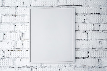 Blank white poster on a white brick wall, mock up