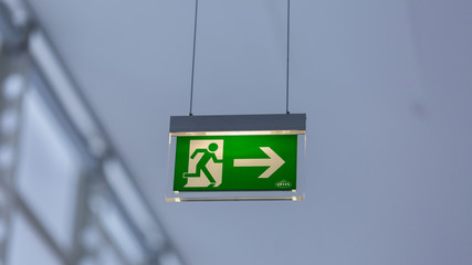 Vienna, Austria - Jan 29, 2020: View on illuminated emergency exit sign. With running figure and...