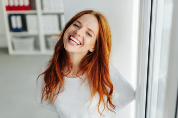 Fun cheeky young woman with a toothy grin