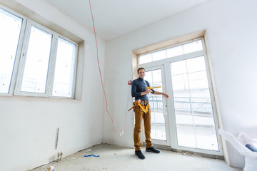 Construction worker installing window in house