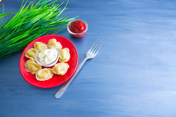 Close up fresh boiled dumplings with hot steams on a plate. Chinese food on rustic old vintage wooden background.