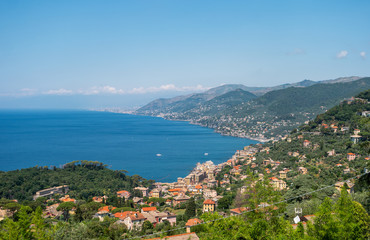 Fototapeta na wymiar Beautiful panoramic view of the city of Camogli, located on the shores of the Ligurian Sea. Traditional Italian houses stretch along the coastline.