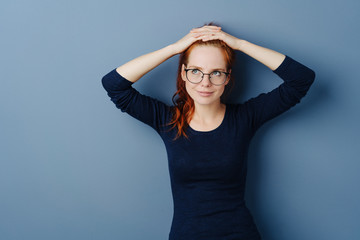 Thoughtful young woman wearing glasses