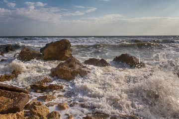 Fototapeta na wymiar Waves stumble across rocks on the coast. Nature