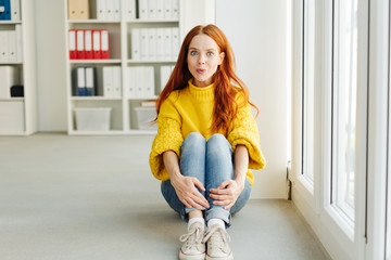 Excited young woman looking at camera with an Ooh
