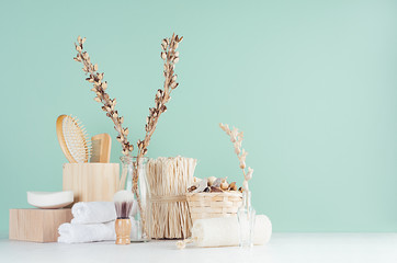 Bathroom interior with beige organic cosmetics and accessories, dried flowers, comb, soap, bath...