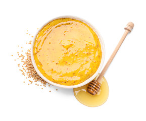 Bowl of tasty honey mustard sauce on white background