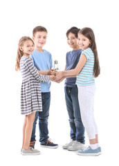 Fototapeta premium Little children holding light bulb with plant on white background. Earth Day celebration